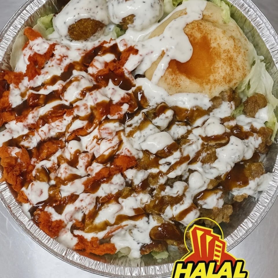 Halal City platter with falafel, chicken, gyro meat, pita, lettuce, and sauces in a foil container.
