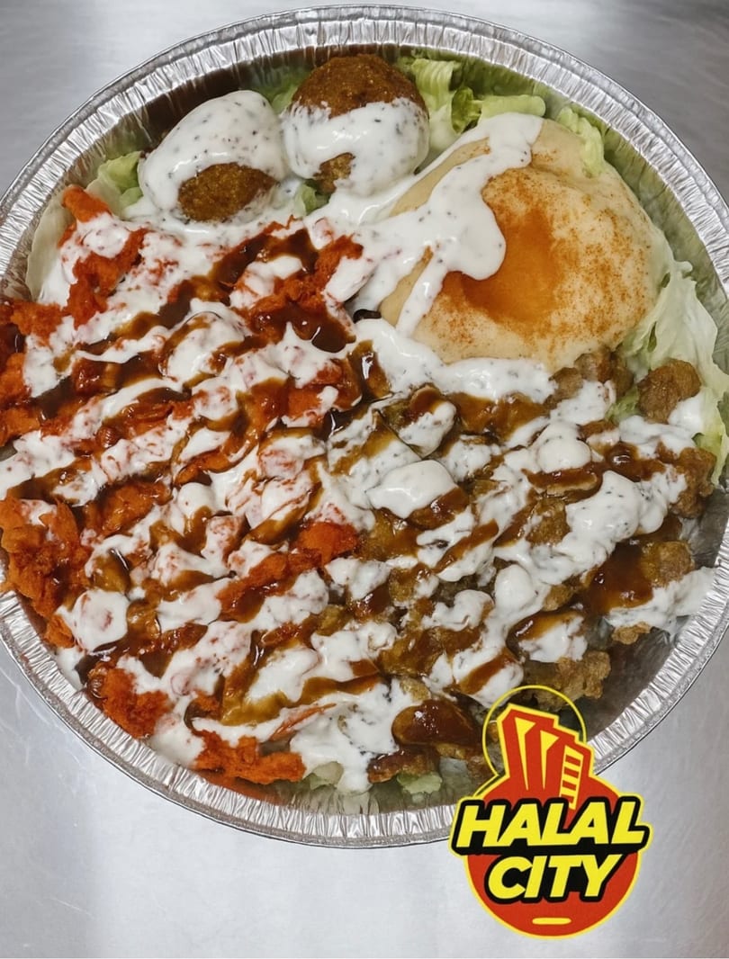 Halal City platter with falafel, chicken, gyro meat, pita, lettuce, and sauces in a foil container.